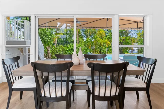 a view of a dining room with furniture a chandelier and wooden floor