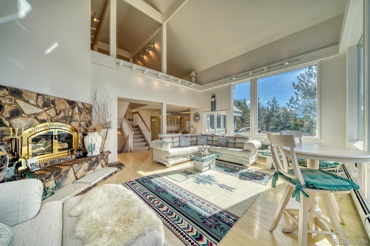 165 Reva Ridge Road Twin Lakes, CO 81251 - Photo 23 of 48 a living room with fireplace furniture and a large window