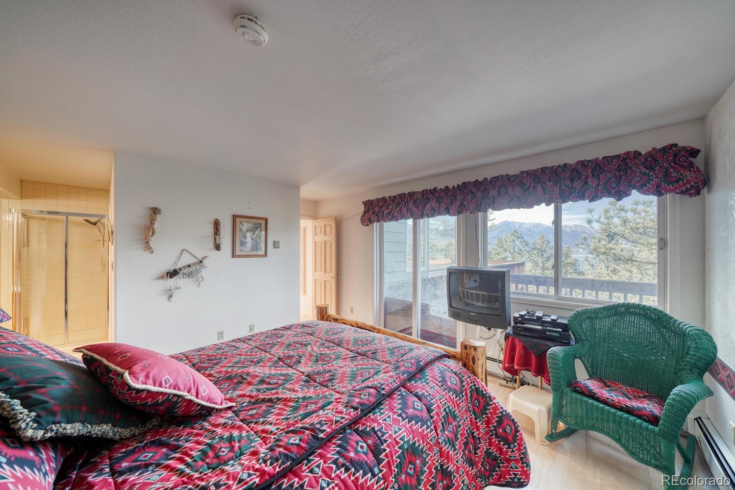 165 Reva Ridge Road Twin Lakes, CO 81251 - Photo 26 of 48 a bedroom with a bed and large windows