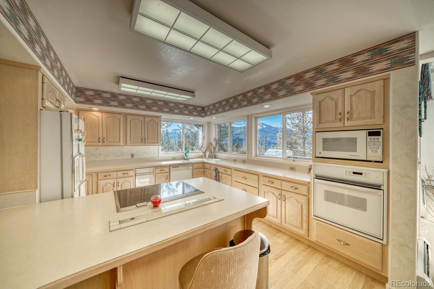 165 Reva Ridge Road Twin Lakes, CO 81251 - Photo 31 of 48 a kitchen with a stove a sink and cabinets