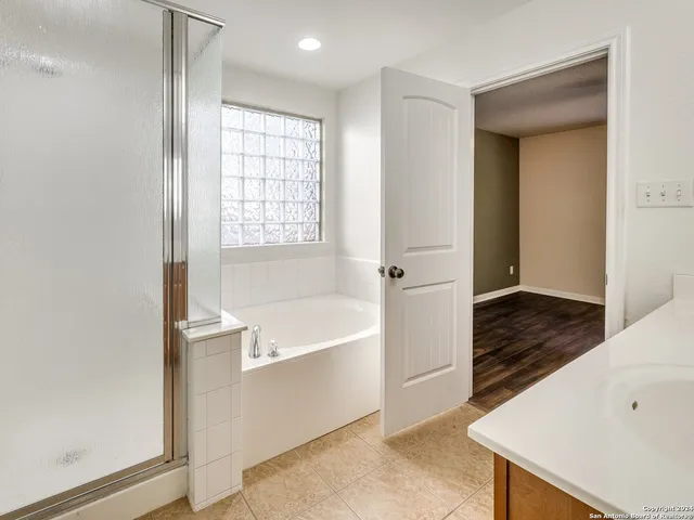 a bathroom with a bathtub and a shower