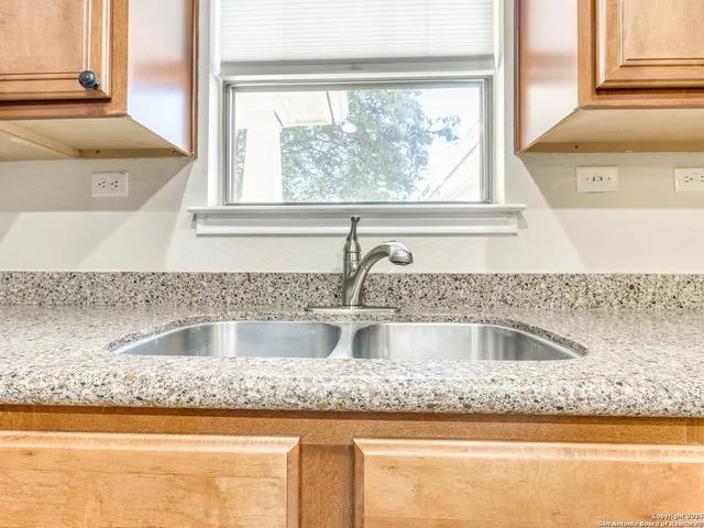 a kitchen with granite countertop a sink and a window