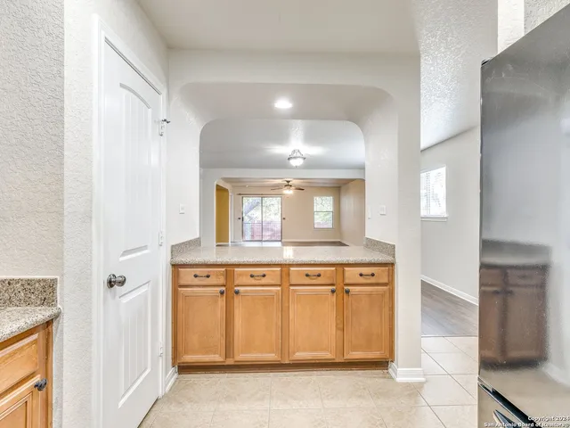 a view of a kitchen with cabinets and wooden floor