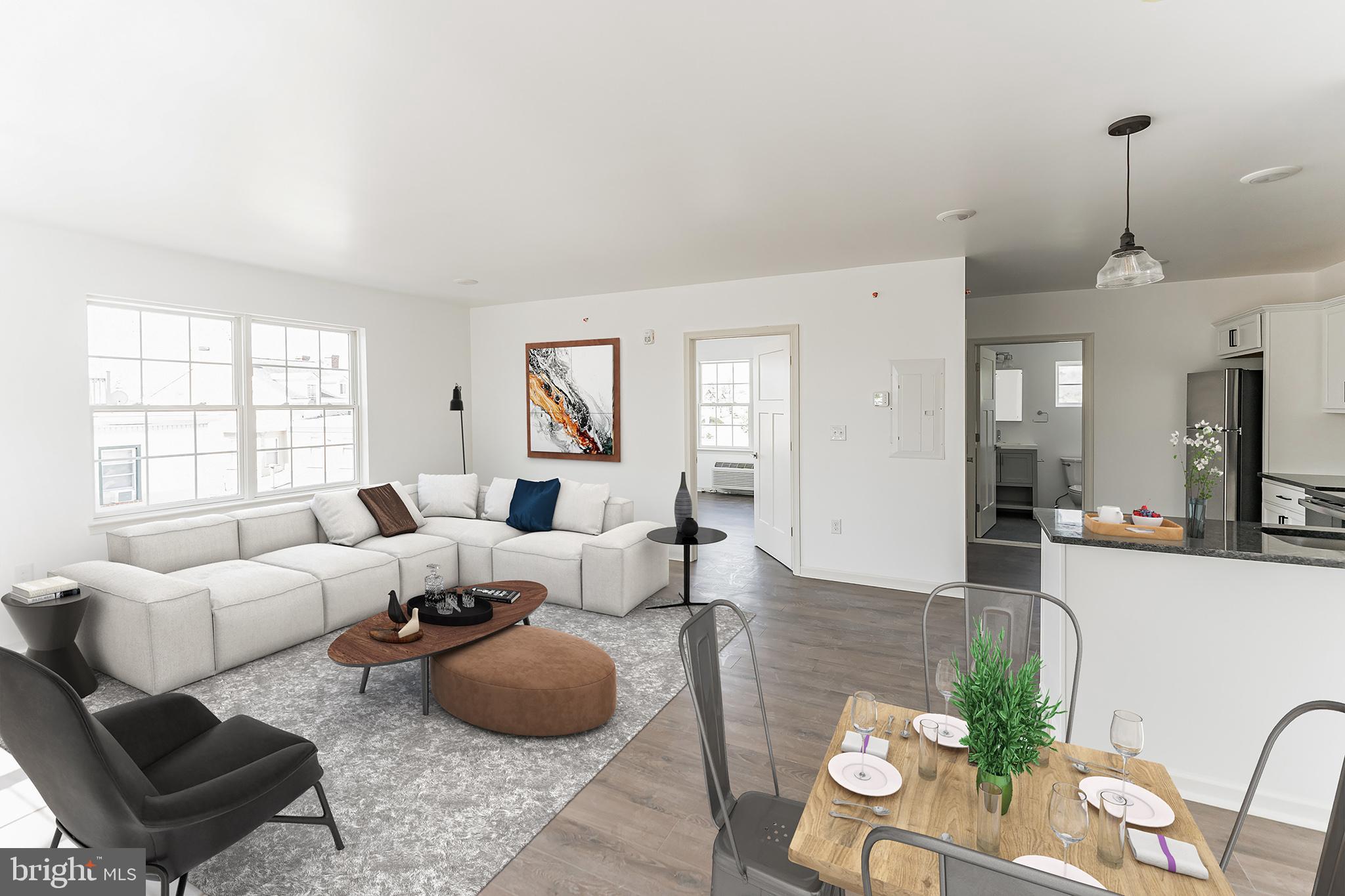 a living room with furniture potted plant and windows