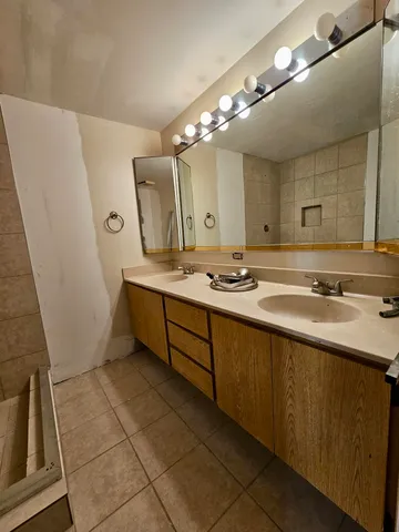 a spacious bathroom with a sink double vanity and a mirror