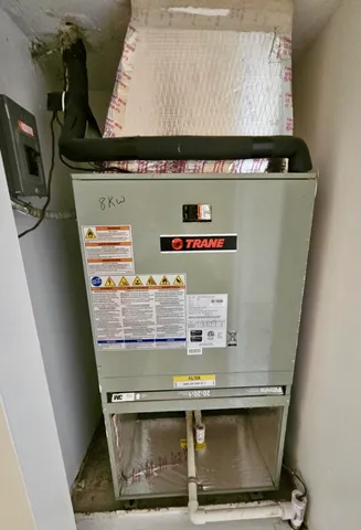 a view of water heater with washer and dryer