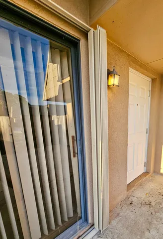 a view of a backyard with plants and wooden fence