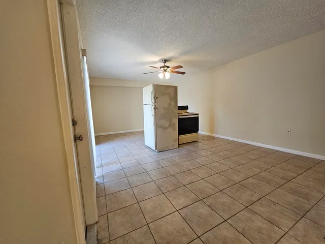 a view of a kitchen with a sink and a refrigerator