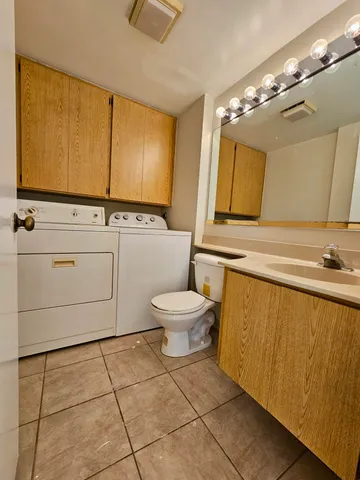 a bathroom with a sink a toilet and mirror