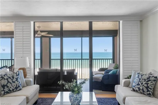 a living room with furniture tv and a window