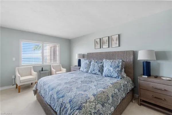 a bedroom with a large bed and a window