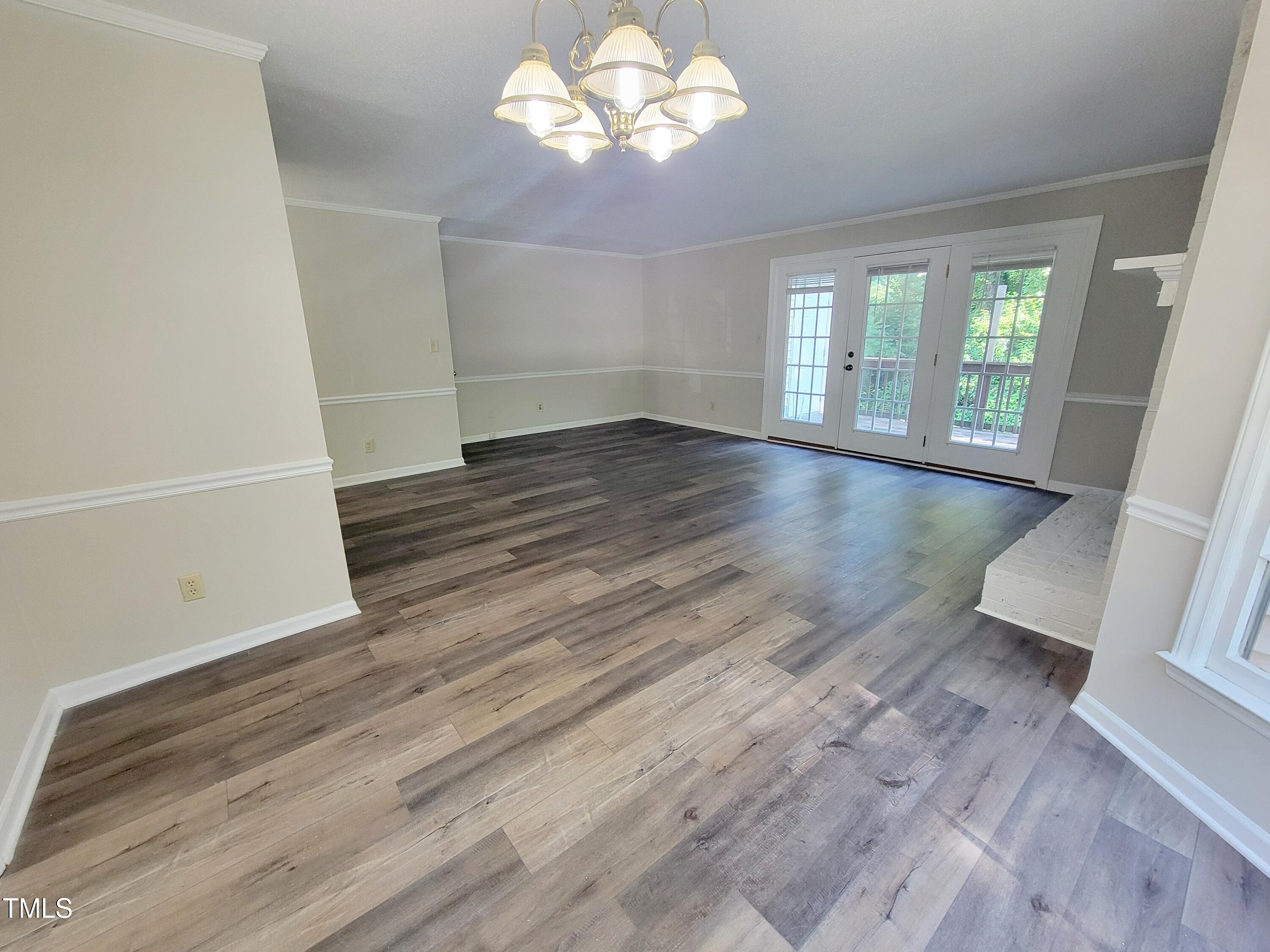 500 Brent Road, Unit 101 Raleigh, NC 27606 - Photo 14 of 62 an empty room with wooden floor and windows