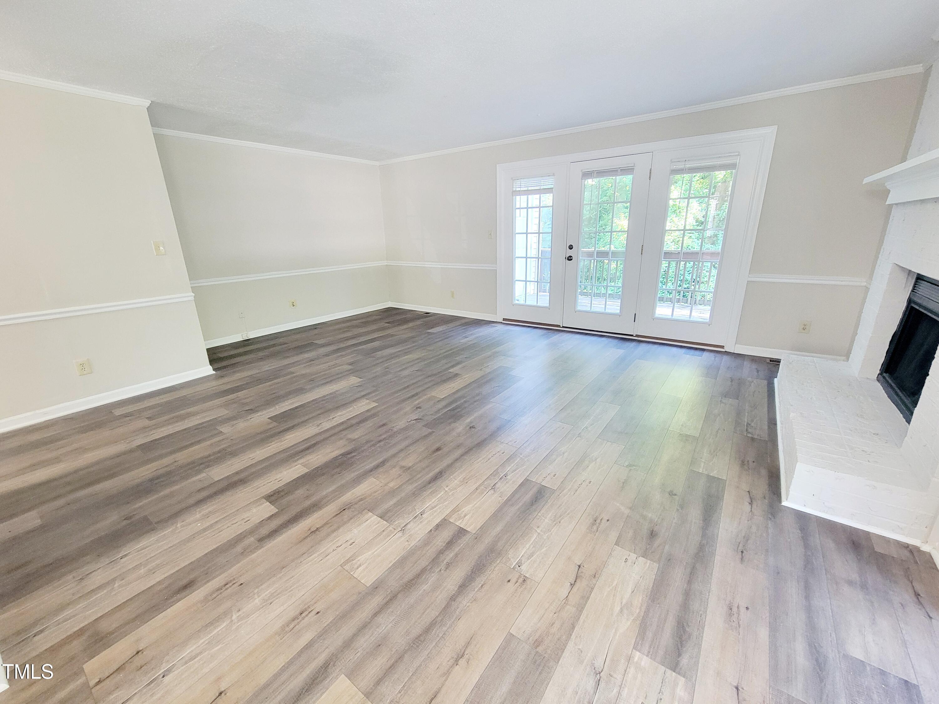 500 Brent Road, Unit 101 Raleigh, NC 27606 - Photo 17 of 62 an empty room with wooden floor and windows
