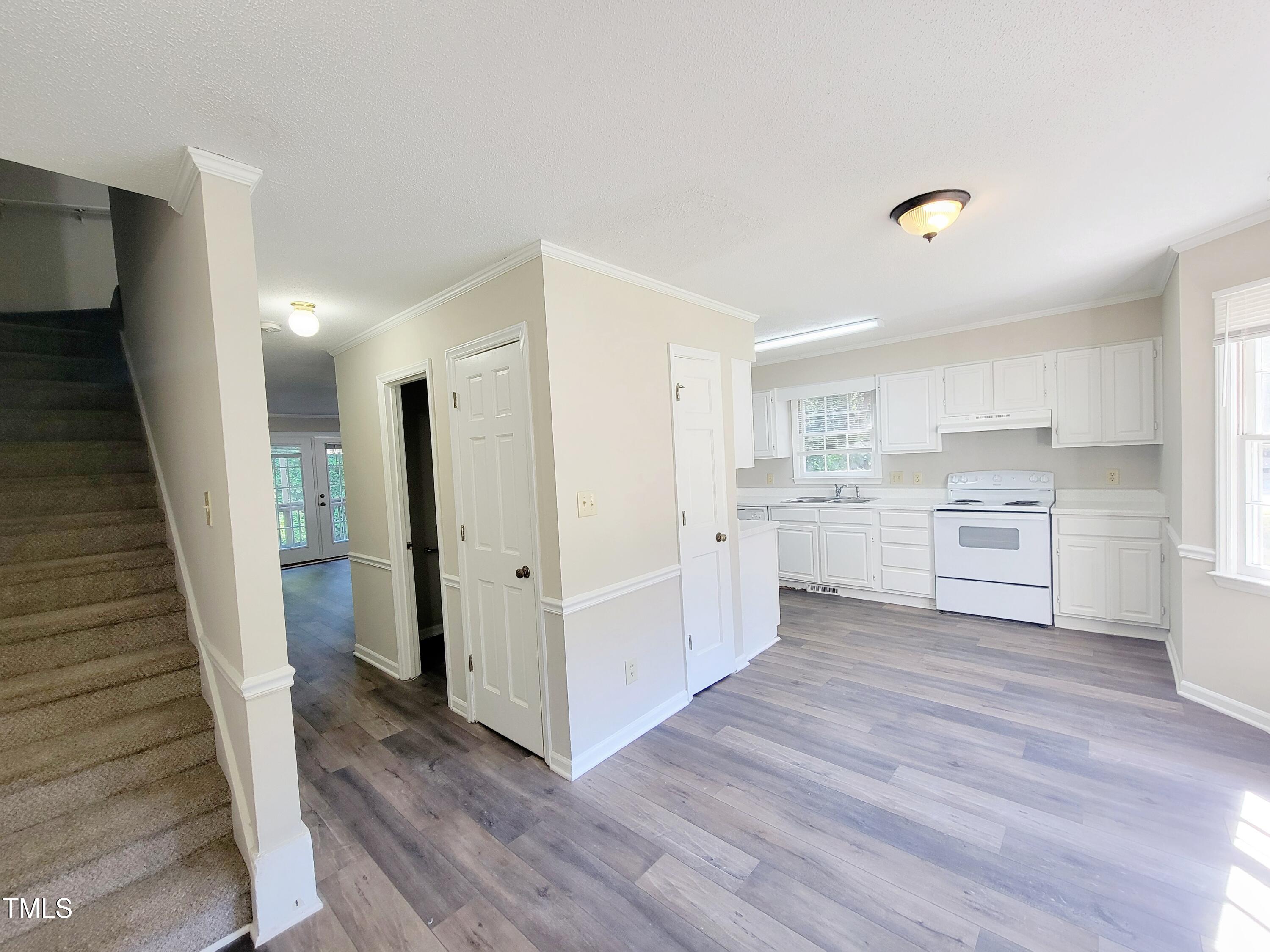 500 Brent Road, Unit 101 Raleigh, NC 27606 - Photo 3 of 62 a view of a kitchen with wooden floor and electronic appliances