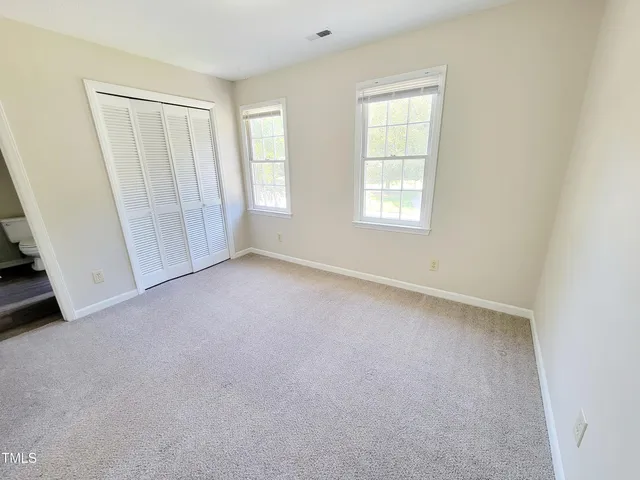 a view of a small space with wooden floor and a window
