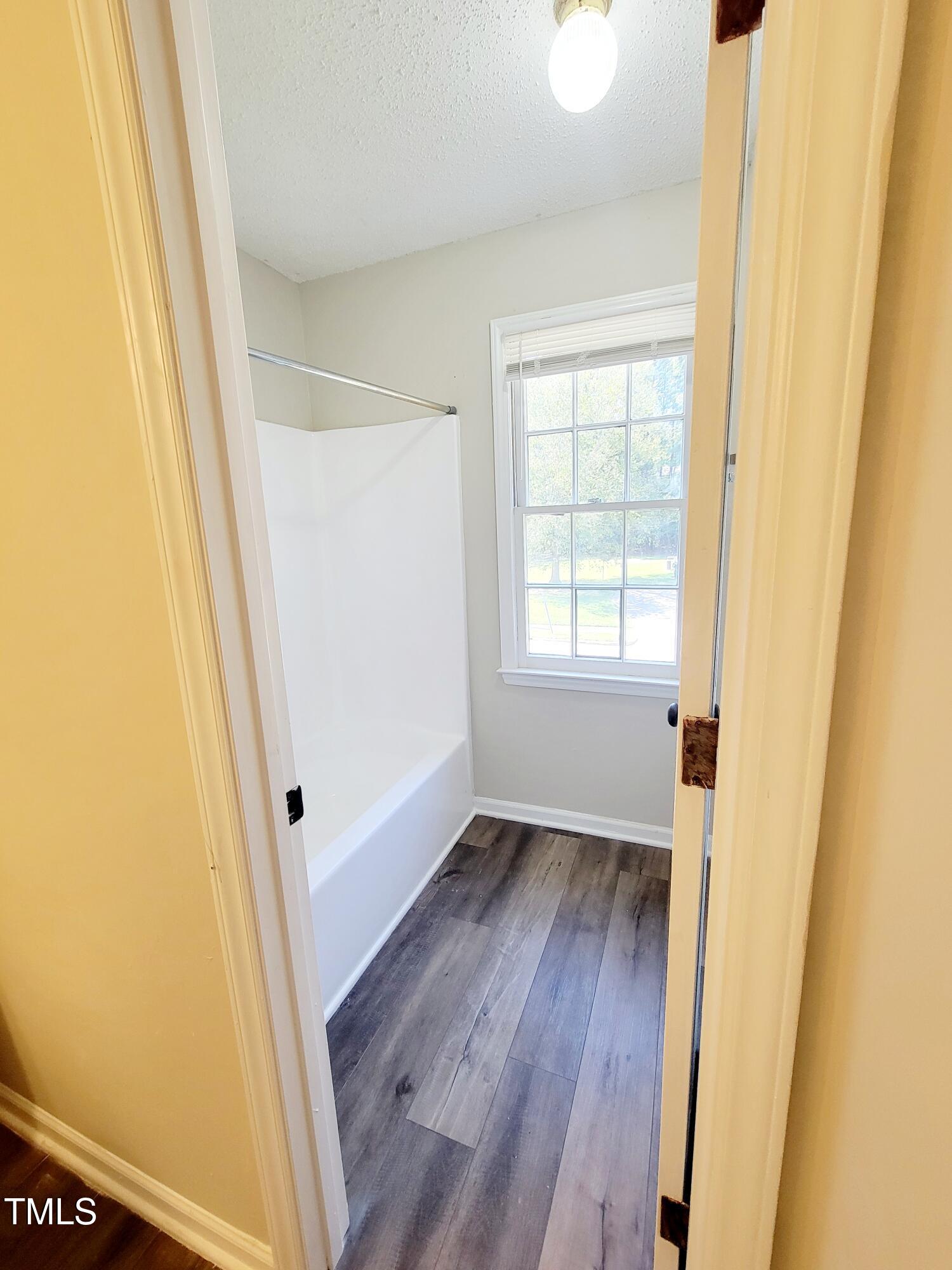 500 Brent Road, Unit 101 Raleigh, NC 27606 - Photo 45 of 62 a view of an empty room with wooden floor and a window