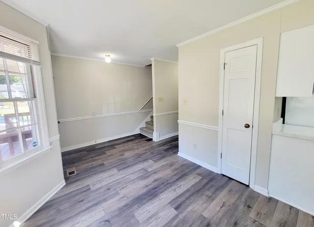 wooden floor in an empty room with a window