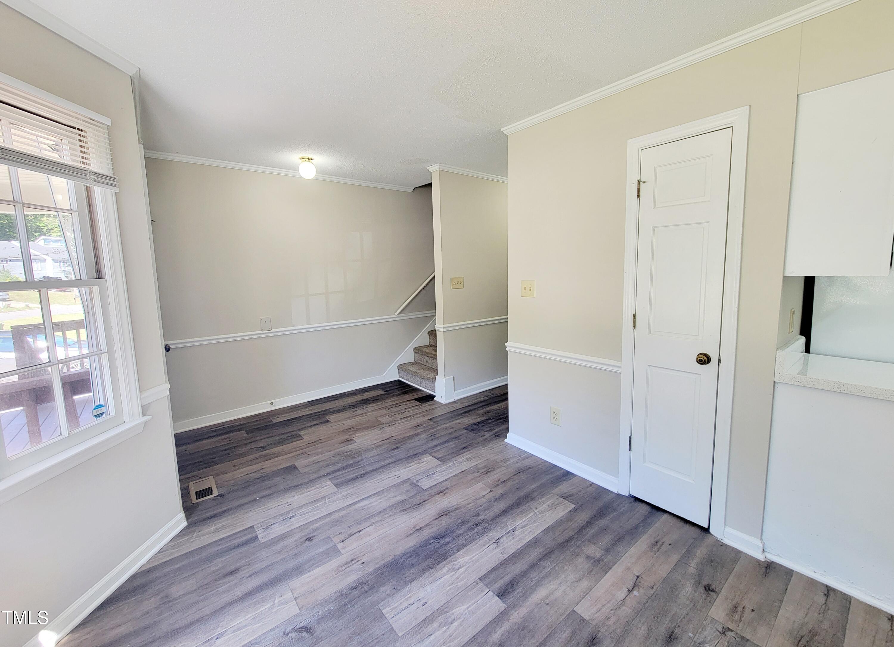 500 Brent Road, Unit 101 Raleigh, NC 27606 - Photo 6 of 62 wooden floor in an empty room with a window