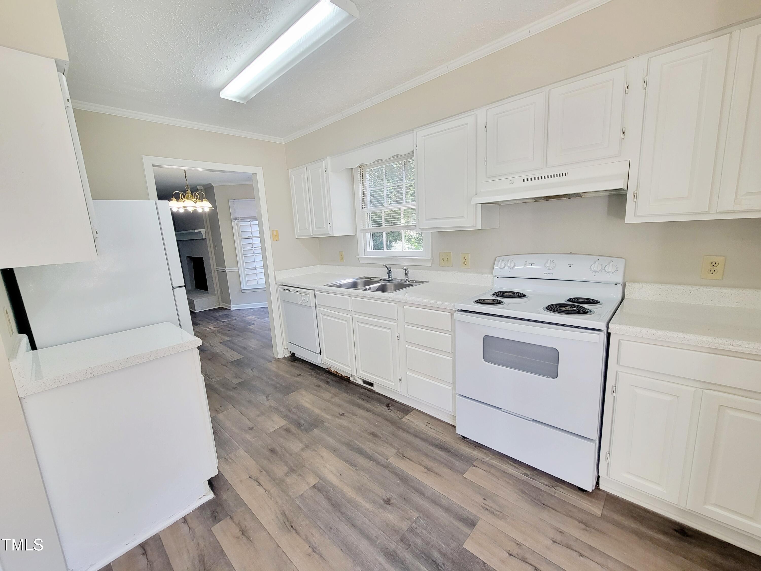 500 Brent Road, Unit 101 Raleigh, NC 27606 - Photo 7 of 62 a kitchen with white cabinets and white appliances