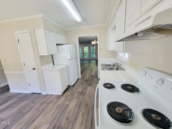 a view of kitchen and white cabinets
