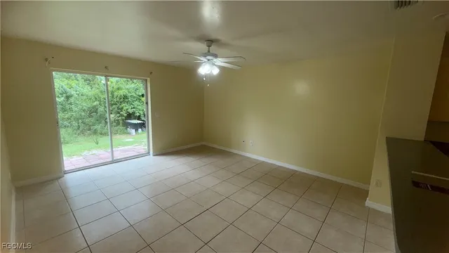 a view of empty room with fan and window