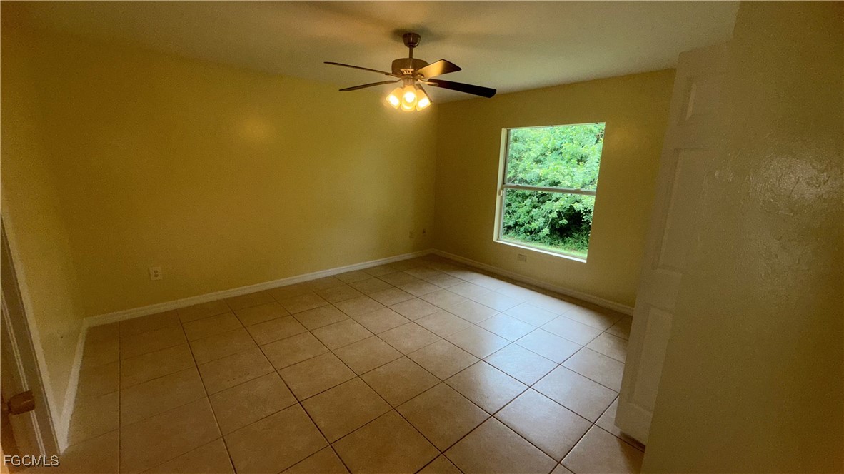 414 East 12th Street Lehigh Acres, FL 33972 - Photo 5 of 9 a view of an empty room and window
