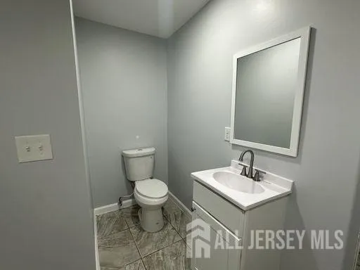 a bathroom with a sink toilet and mirror