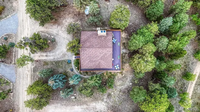 an aerial view of a house by greenery space