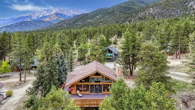 an aerial view of house with yard and trees in the background