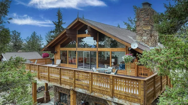 a view of a house with large windows and a small yard