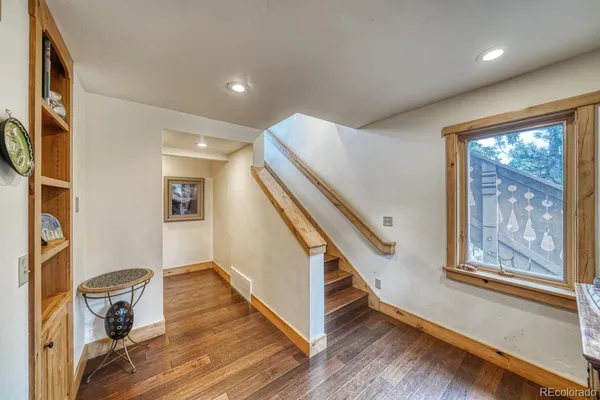a view of entryway with wooden floor and stairs