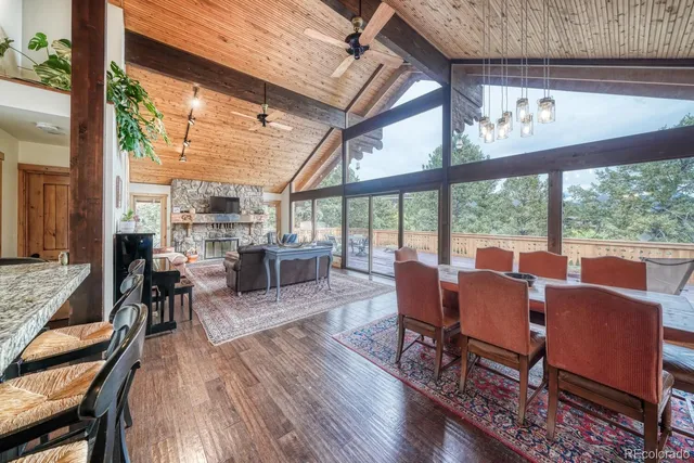 a dining room with furniture water view and large windows