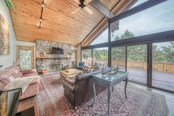 a living room with furniture and large windows