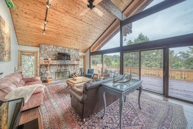 a living room with furniture and large windows