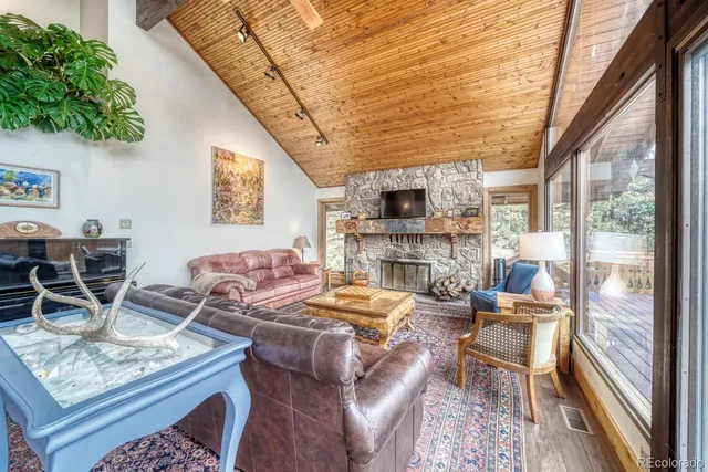 a living room with fireplace furniture and a floor to ceiling window