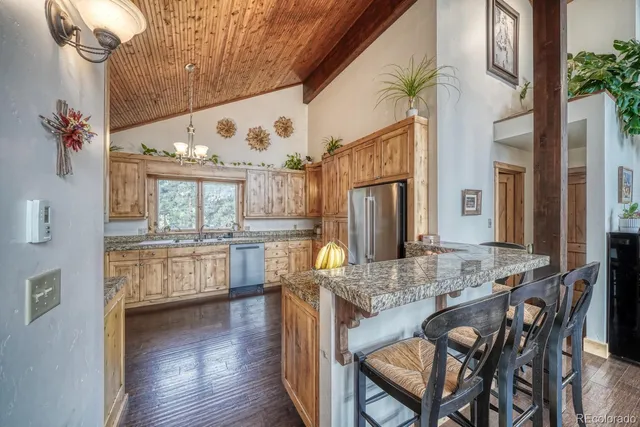 a dining room with furniture and a large window