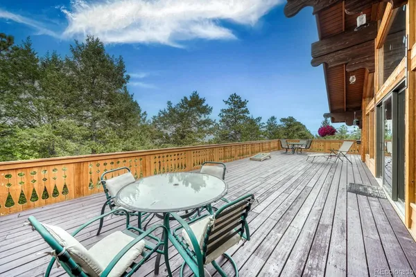 a view of balcony with wooden floor and outdoor seating