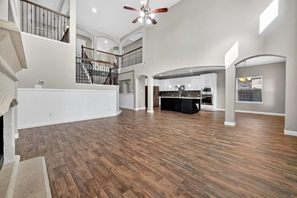5710 Metaphor Way Richmond, TX 77469 - Photo 12 of 41 The living room’s open flow leads naturally into the kitchen and breakfast area through grand archways, ideal for both gatherings and everyday ease.