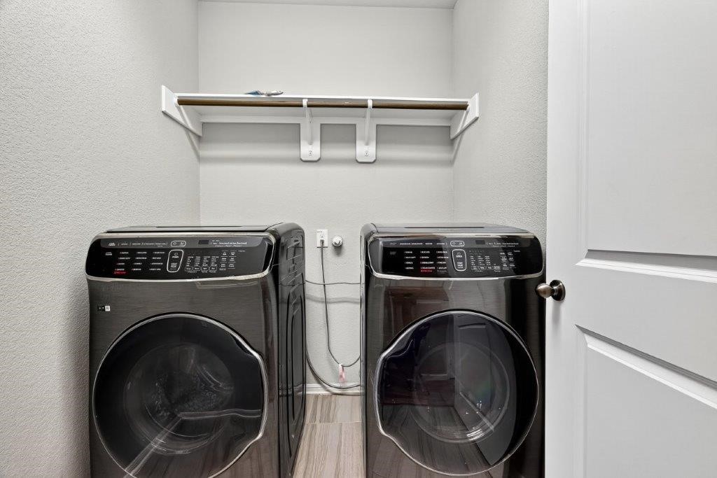 5710 Metaphor Way Richmond, TX 77469 - Photo 17 of 41 The laundry room is both spacious and functional, with built-in shelving offering organized storage above.