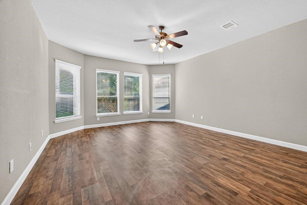 5710 Metaphor Way Richmond, TX 77469 - Photo 18 of 41 The curve of windows here feels like a quiet embrace, letting in soft daylight that turns the primary bedroom into a sanctuary at every hour.