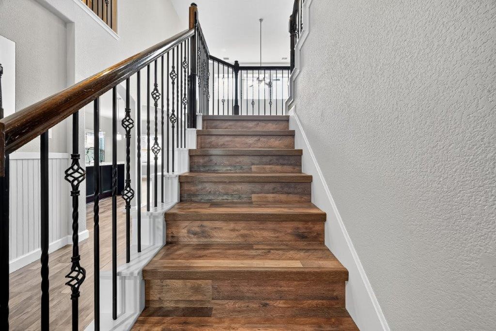 5710 Metaphor Way Richmond, TX 77469 - Photo 25 of 41 The staircase showcases rich wood tones, iron balusters, and a sweeping handrail, lending artistry to the home’s architecture.