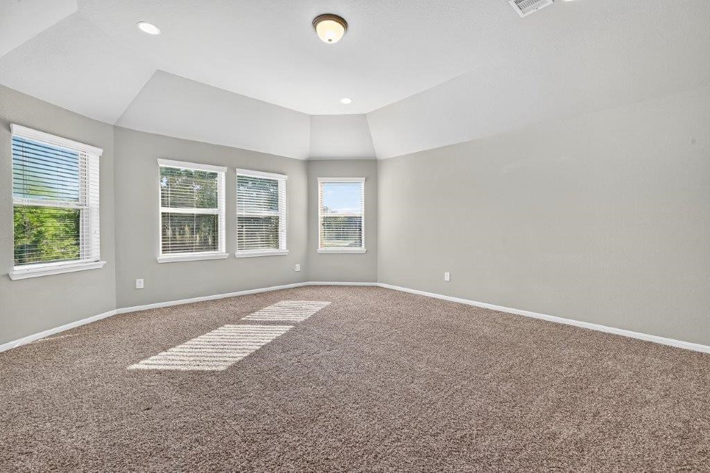 5710 Metaphor Way Richmond, TX 77469 - Photo 26 of 41 The upstairs game room is expansive, with raised ceilings, plush carpeting, and windows that invite natural light for a bright, versatile space.