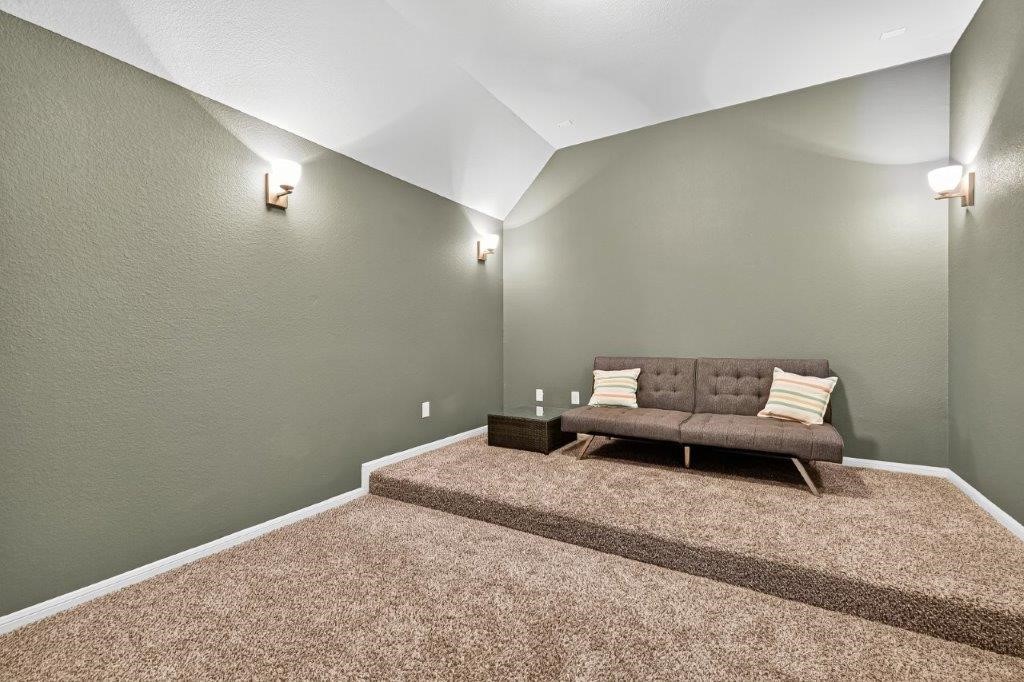 5710 Metaphor Way Richmond, TX 77469 - Photo 28 of 41 Step into a private cinema where the tiered floor invites cozy recliners, and the glow of sconces sets the mood for stories to unfold on the screen.