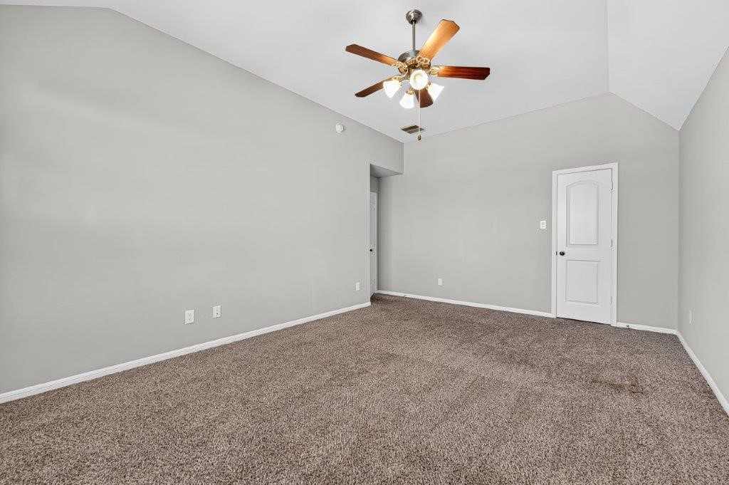 5710 Metaphor Way Richmond, TX 77469 - Photo 29 of 41 A secondary bedroom offers space and comfort with carpeting underfoot and a ceiling fan overhead.