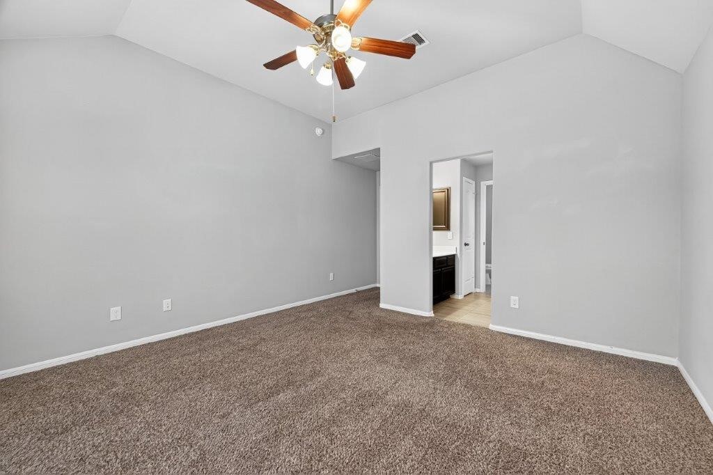 5710 Metaphor Way Richmond, TX 77469 - Photo 31 of 41 This bedroom includes its own vanity and direct access to a connected bath, adding convenience and privacy.