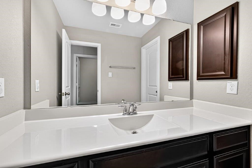 5710 Metaphor Way Richmond, TX 77469 - Photo 32 of 41 A large vanity with ample lighting provides both function and elegance in one of the home’s full baths.