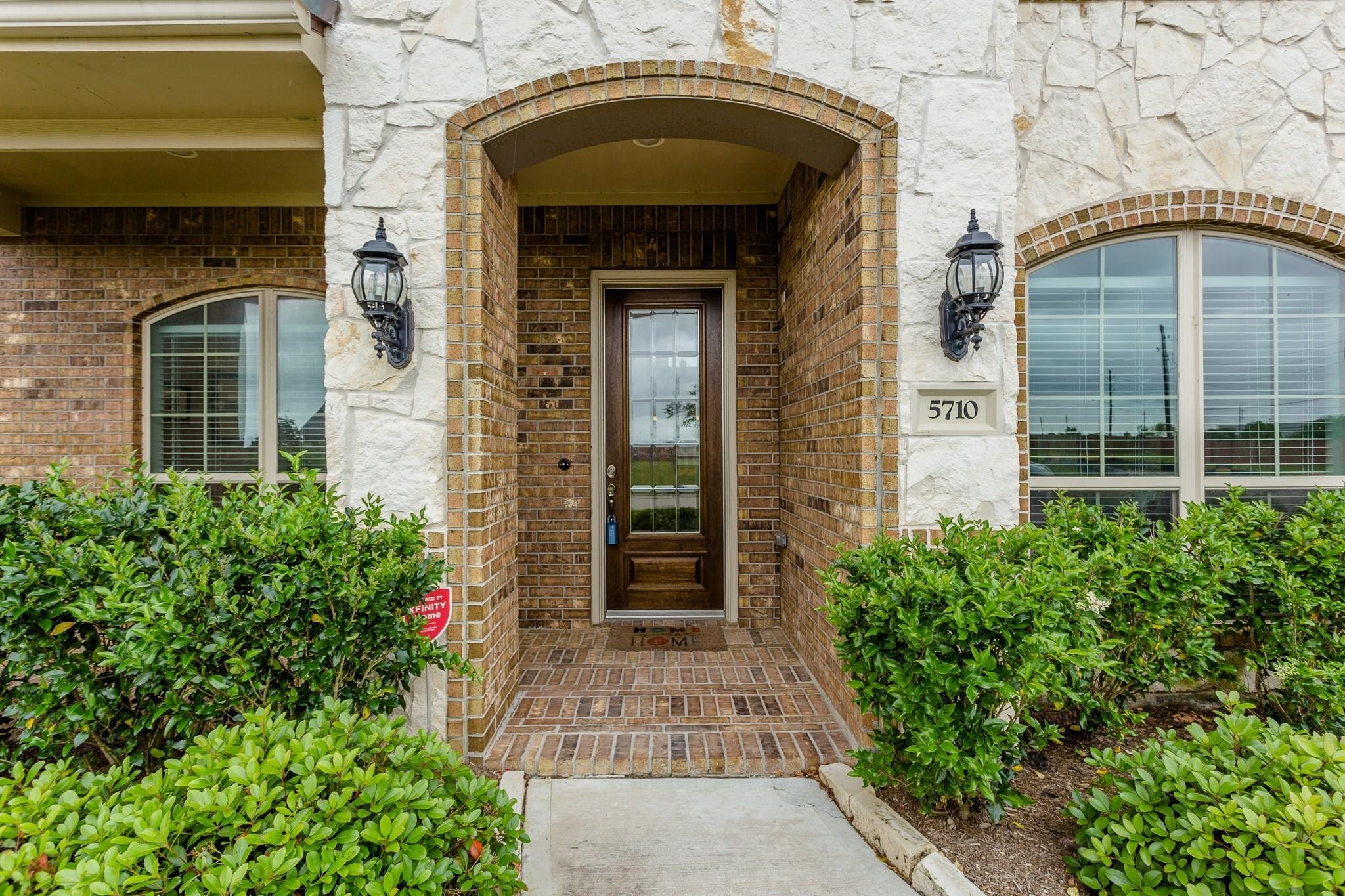 5710 Metaphor Way Richmond, TX 77469 - Photo 4 of 41 The recessed front entry, set within a brick surround, is accentuated by a glass-paneled door and a spacious porch perfect for greeting guests in style.
