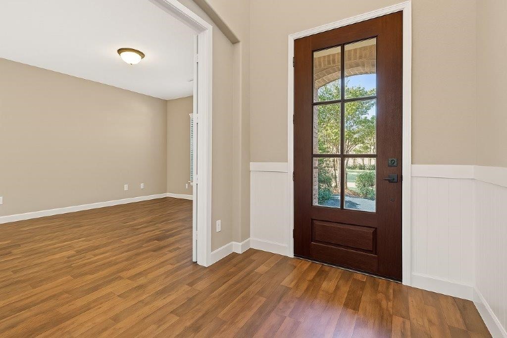 5710 Metaphor Way Richmond, TX 77469 - Photo 5 of 41 From inside, the front door opens to a refined entryway, where a formal living room rests to the side, setting a graceful tone for the home.