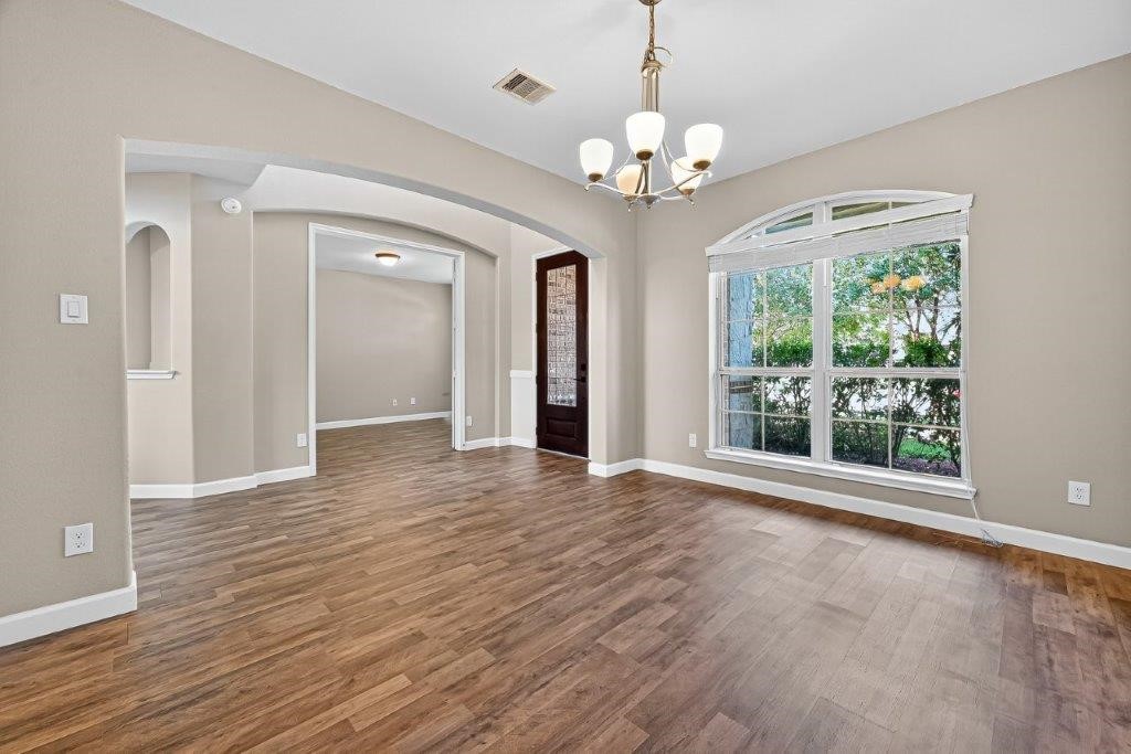 5710 Metaphor Way Richmond, TX 77469 - Photo 6 of 41 The formal dining room is filled with natural light from an oversized arched window, its polished wood flooring enhancing the seamless flow into the butler’s pantry and kitchen.