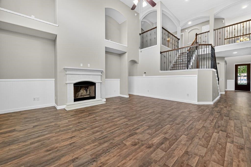 5710 Metaphor Way Richmond, TX 77469 - Photo 10 of 41 The living room feels almost theatrical, where arches, niches, and soaring ceilings create a stage for everyday life. The sweeping staircase adds drama while keeping the scene timeless.